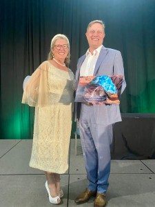 Joan Koerber-Walker, president and chief executive officer of AZBio, presents Dr. David Spetzler, President, Chief Scientific Officer, Caris Life Sciences, with the Arizona Bioscience Company of the Year Award